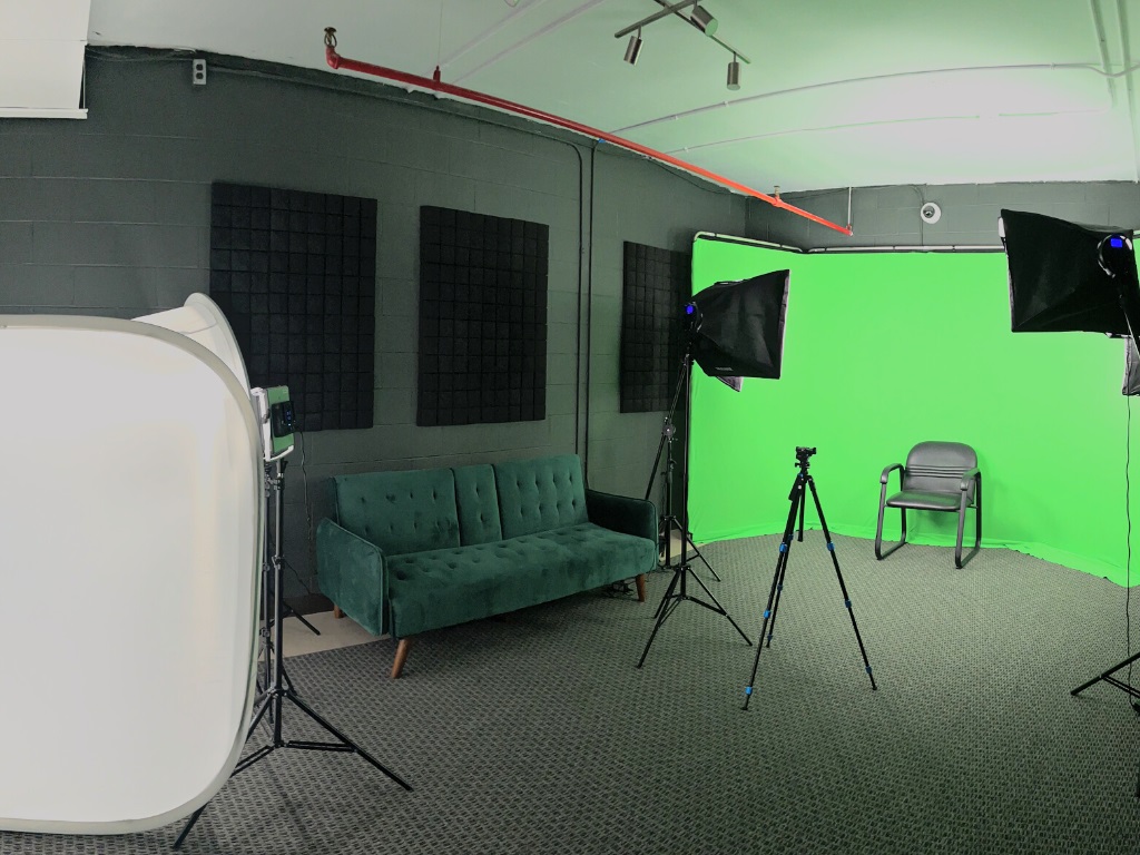 Video and photography studio. Studio lights, green screen, a couch and product lightbox